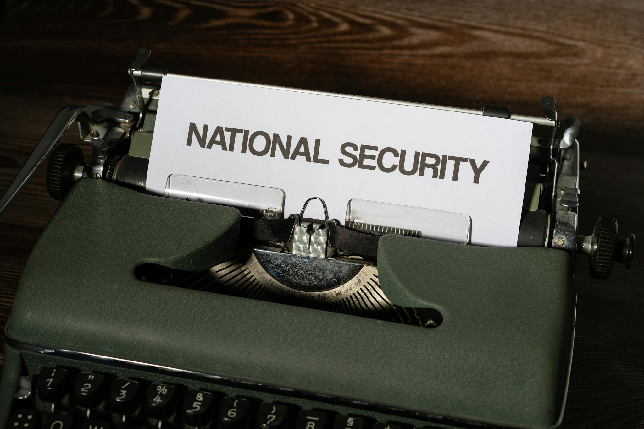 Close-up of a vintage typewriter with a paper showing the words 'National Security.'
